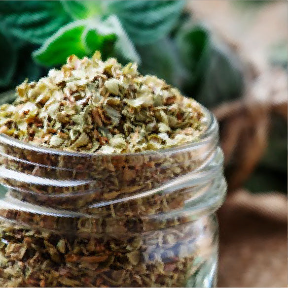 Glass jar filled with chopped dried oregano spice