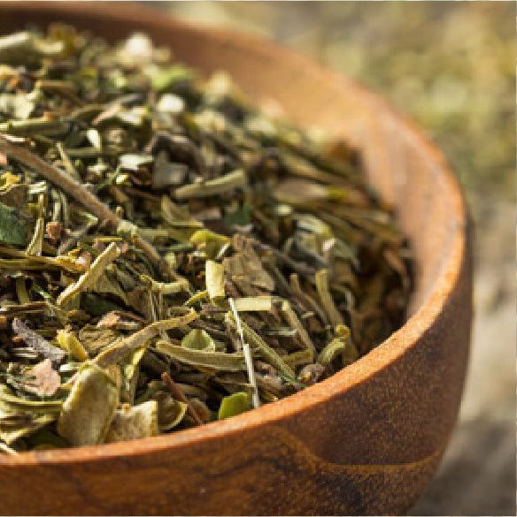 Close up of savory spice blend with dried herbs in a rustic wooden bowl
