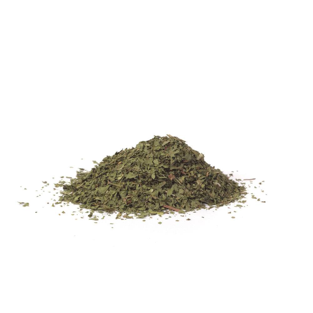 Pile of dried cilantro leaves on white background
