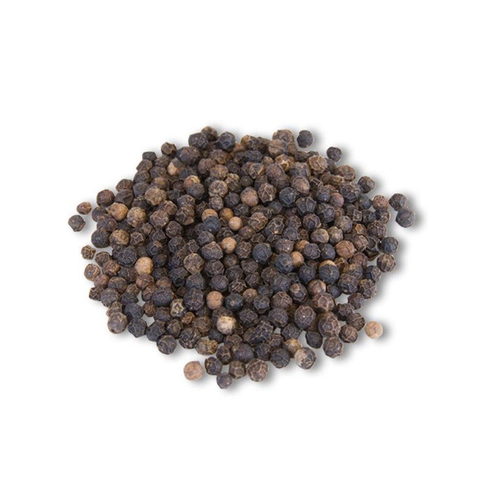 Pile of whole black peppercorns on a white background